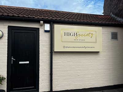 High Society logo and sign outside building